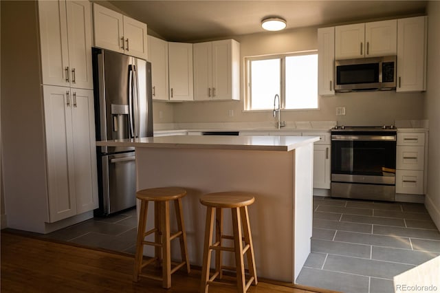 38810 Jacobson Rd, Rush, CO 80833 - kitchen featuring appliances with stainless steel finishes, a kitchen island, and white cabinets