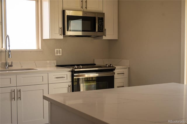 38810 Jacobson Rd, Rush, CO 80833 - kitchen with stainless steel appliances and white cabinets