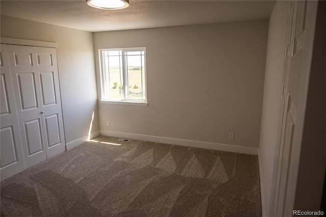 38810 Jacobson Rd, Rush, CO 80833 - unfurnished bedroom featuring carpet flooring, a textured ceiling, and a closet