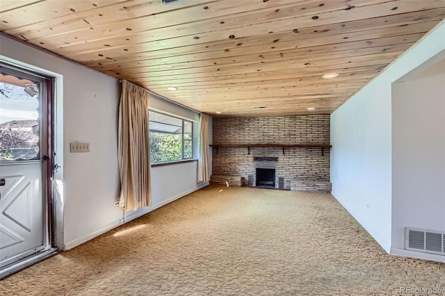 unfurnished living room with carpet floors, wooden ceiling, visible vents, and a fireplace