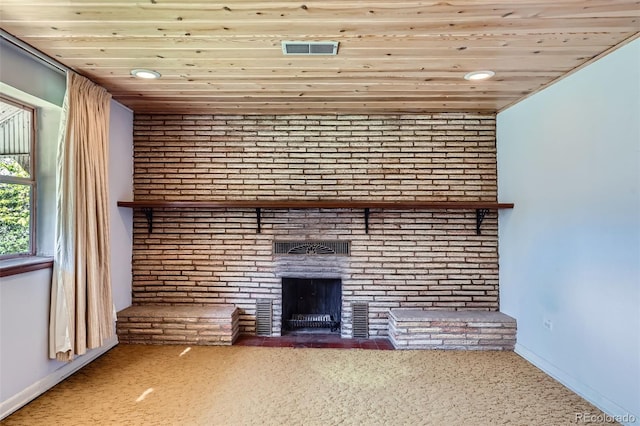 unfurnished living room with visible vents, baseboards, a brick fireplace, and wood ceiling