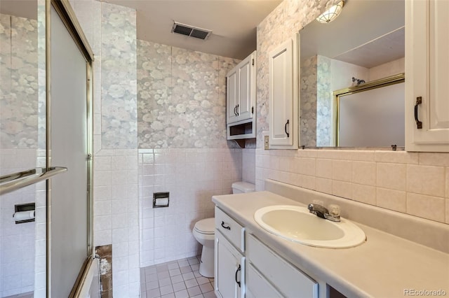 full bath featuring visible vents, toilet, tile walls, tile patterned flooring, and a stall shower