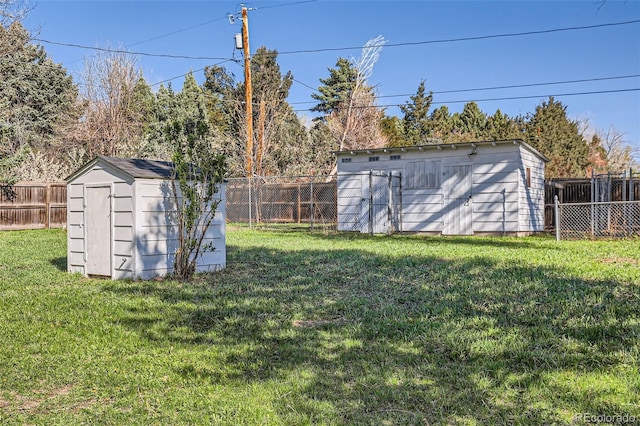 view of yard featuring a storage unit, a fenced backyard, and an outdoor structure