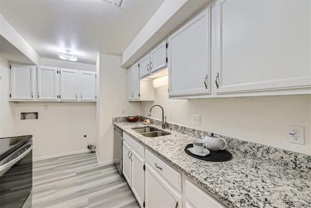 kitchen featuring light stone countertops, a textured ceiling, white cabinets, appliances with stainless steel finishes, and sink