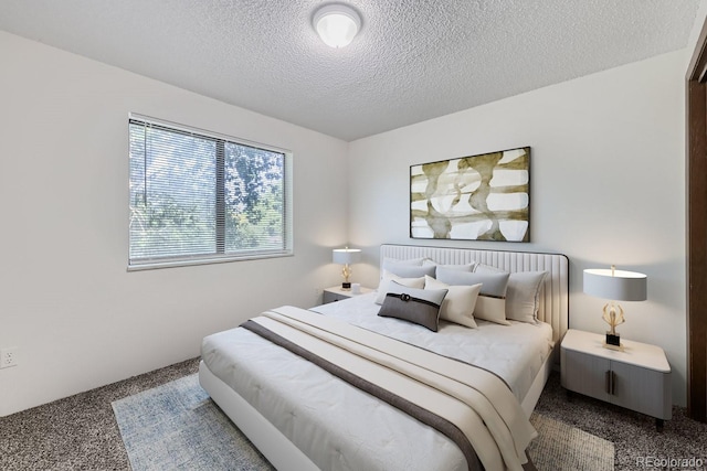 carpeted bedroom featuring a textured ceiling