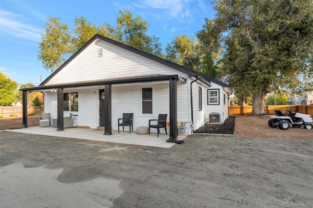 view of front of property featuring a patio area and cooling unit