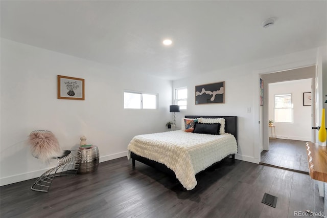 bedroom featuring dark wood-type flooring and multiple windows