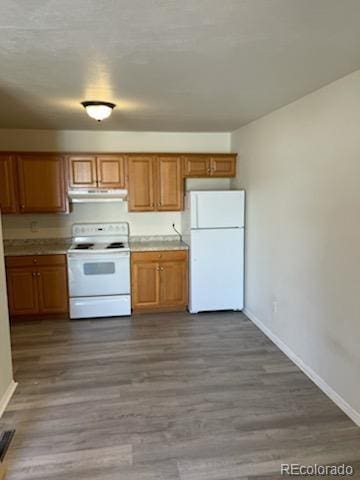 kitchen with hardwood / wood-style floors and white appliances