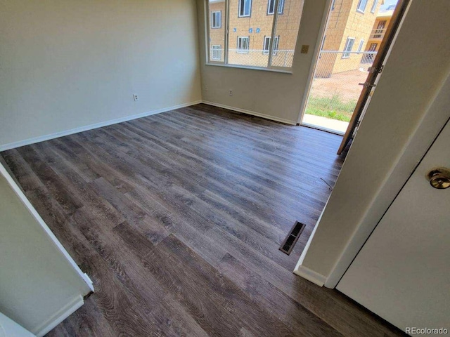 empty room with dark hardwood / wood-style floors