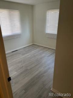 unfurnished room with wood-type flooring