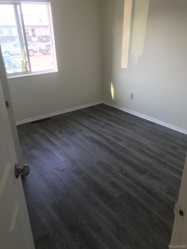 spare room with hardwood / wood-style floors