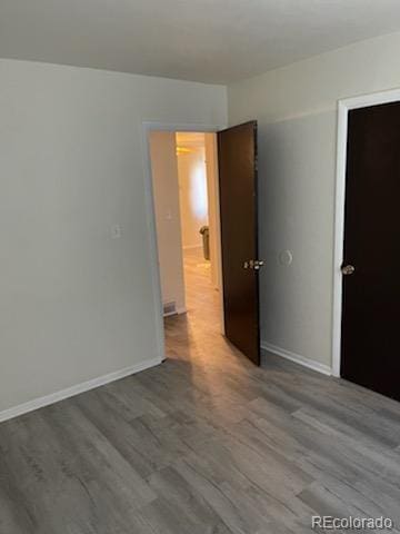 unfurnished room with wood-type flooring