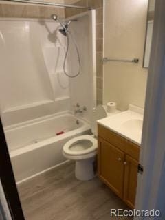 full bathroom with vanity, toilet, shower / tub combination, and hardwood / wood-style floors