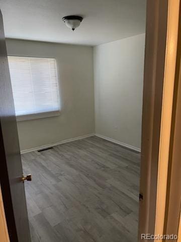 unfurnished room with hardwood / wood-style floors