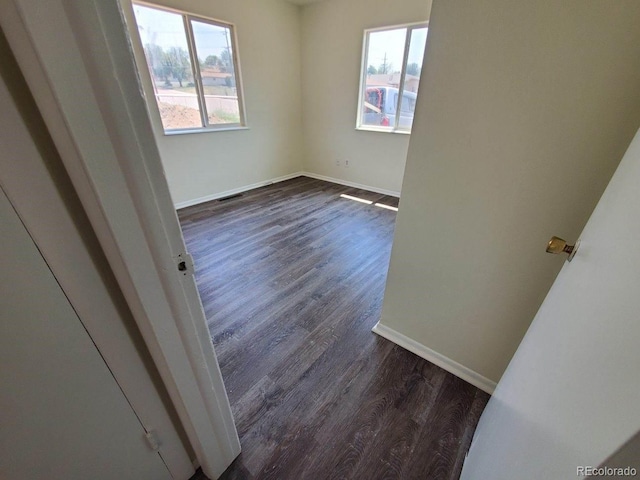 unfurnished room featuring dark wood-type flooring