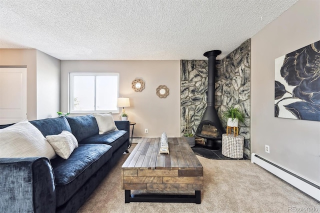 living room featuring baseboard heating, carpet flooring, and a textured ceiling