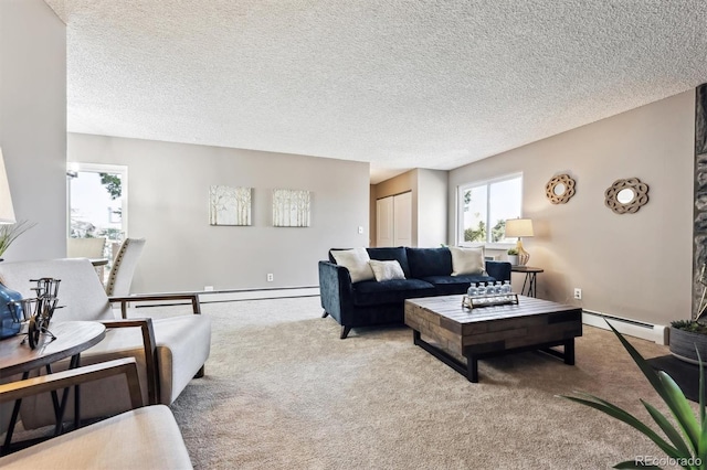 carpeted living room featuring baseboard heating, a healthy amount of sunlight, and a textured ceiling