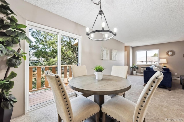 dining area with light carpet, a notable chandelier, a textured ceiling, and a baseboard heating unit