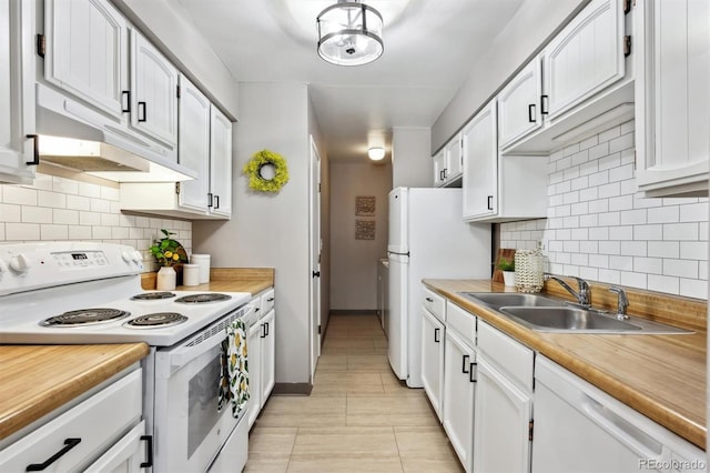 kitchen featuring white appliances, white cabinets, light countertops, and a sink