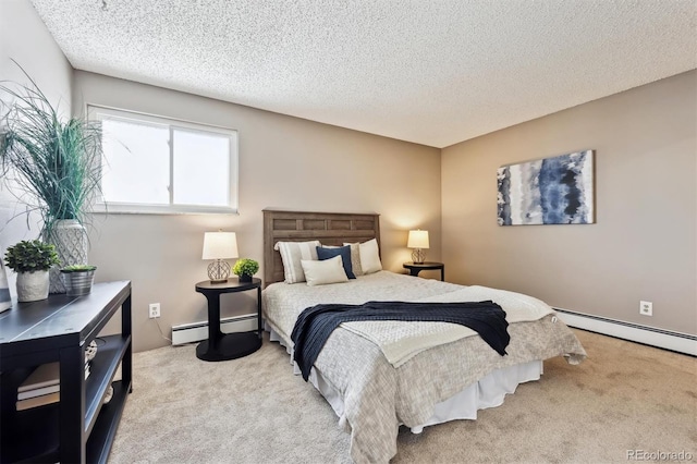 carpeted bedroom with a baseboard heating unit and a textured ceiling