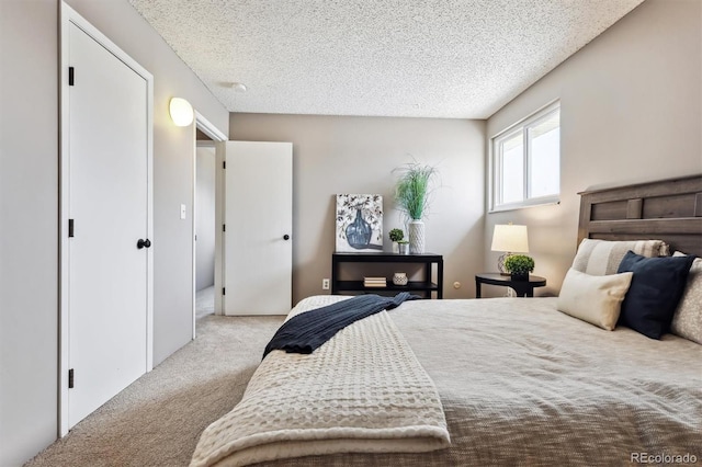 bedroom featuring a textured ceiling and carpet floors