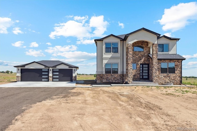 995 Pinehurst Ct, Bennett, CO 80102 - contemporary house with stone siding, stucco siding, a garage, and driveway