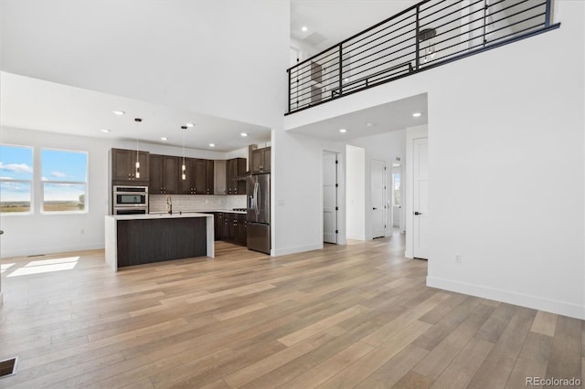 995 Pinehurst Ct, Bennett, CO 80102 - unfurnished living room featuring light wood finished floors and recessed lighting