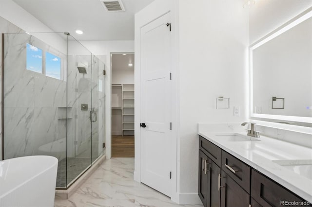 995 Pinehurst Ct, Bennett, CO 80102 - full bath featuring marble finish floors, a marble finish shower, a soaking tub, double vanity, and recessed lighting