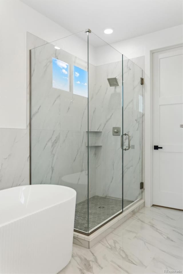 995 Pinehurst Ct, Bennett, CO 80102 - bathroom featuring marble finish floors, a freestanding bath, a marble finish shower, and recessed lighting
