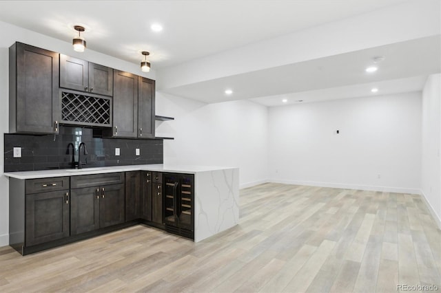 995 Pinehurst Ct, Bennett, CO 80102 - indoor wet bar with beverage cooler, light wood-style flooring, tasteful backsplash, and recessed lighting