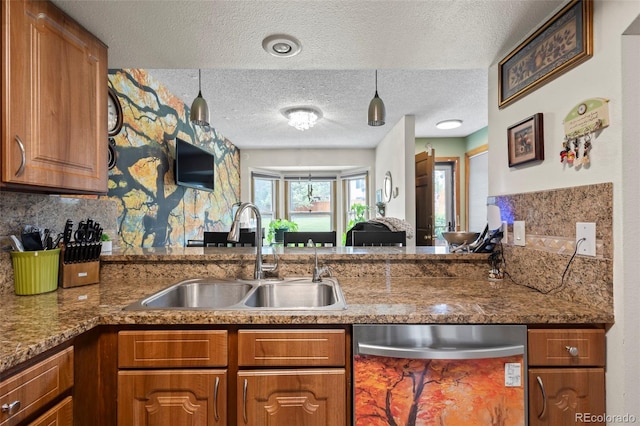 15149 E Princeton Pl Unit B, Aurora, CO 80014 - kitchen with dishwasher, a sink, brown cabinetry, a textured ceiling, and tasteful backsplash