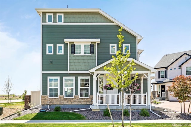 view of front of property with a porch and stone siding