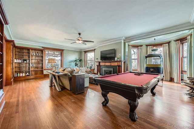 playroom featuring a fireplace, a ceiling fan, billiards, wood finished floors, and ornamental molding