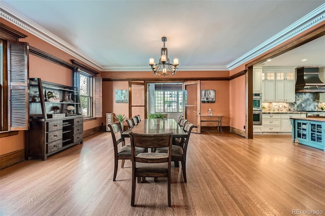 dining room with baseboards, an inviting chandelier, plenty of natural light, and light wood finished floors