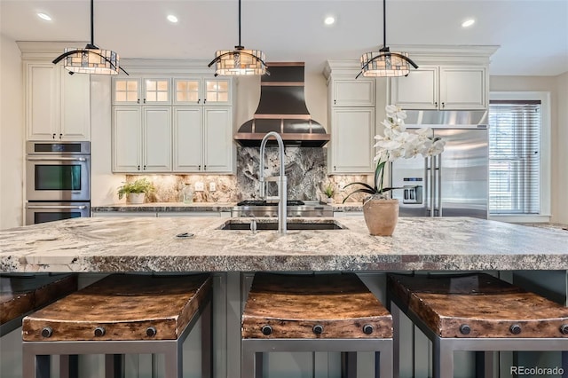 kitchen featuring backsplash, stainless steel appliances, extractor fan, and recessed lighting