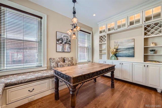 home office with built in shelves and wood finished floors