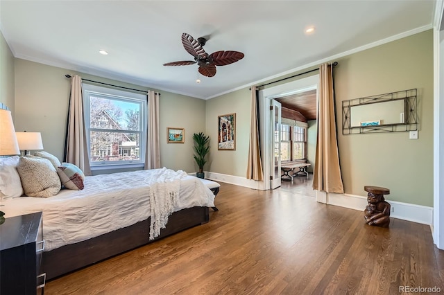 bedroom with baseboards, multiple windows, ornamental molding, and dark wood finished floors
