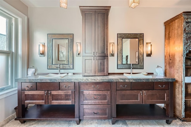 bathroom with a sink and double vanity