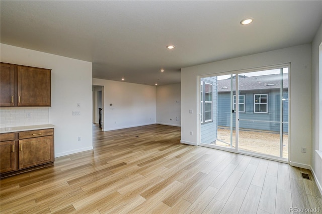 23909 E 41st Ave, Aurora, CO 80019 - unfurnished living room featuring light wood-type flooring, baseboards, and recessed lighting