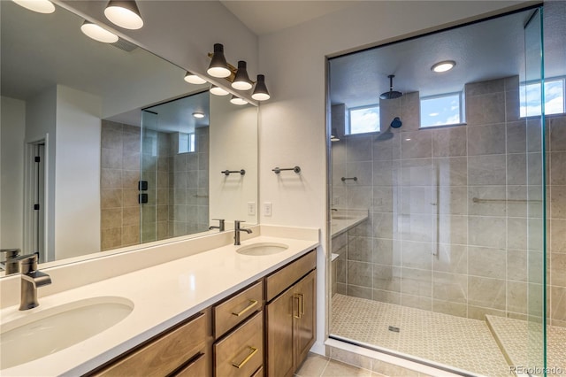 23909 E 41st Ave, Aurora, CO 80019 - full bath featuring tiled shower, plenty of natural light, double vanity, and tile patterned flooring