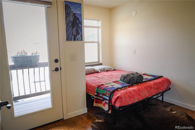 bedroom featuring baseboards and wood finished floors