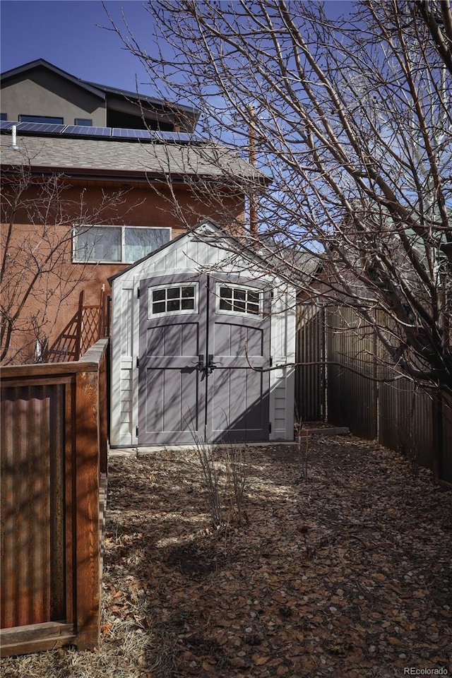 view of shed featuring fence