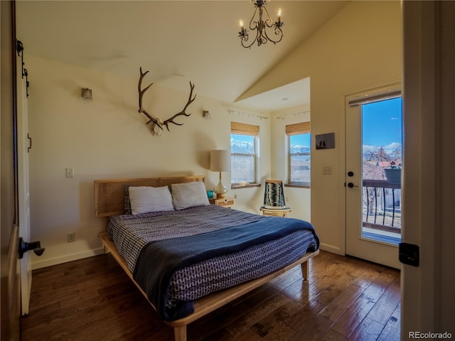 bedroom with vaulted ceiling, access to exterior, multiple windows, a notable chandelier, and hardwood / wood-style flooring