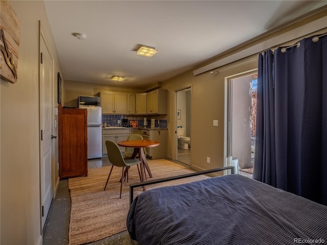 bedroom with freestanding refrigerator