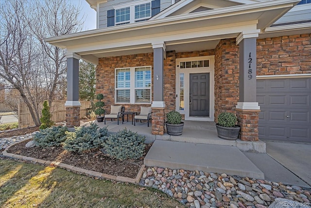 doorway to property featuring stone siding and covered porch