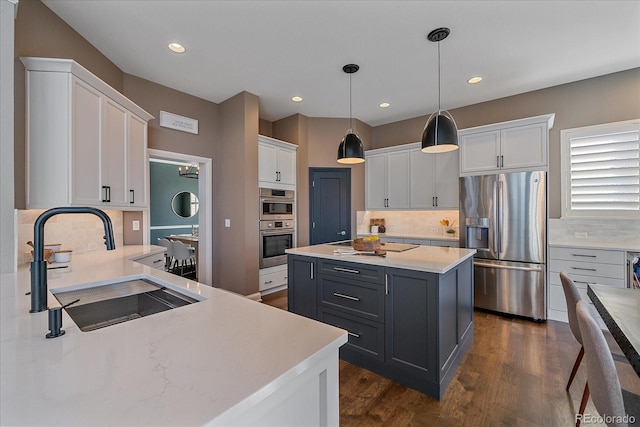 kitchen with stainless steel fridge with ice dispenser, a sink, hanging light fixtures, dark wood-type flooring, and white cabinets