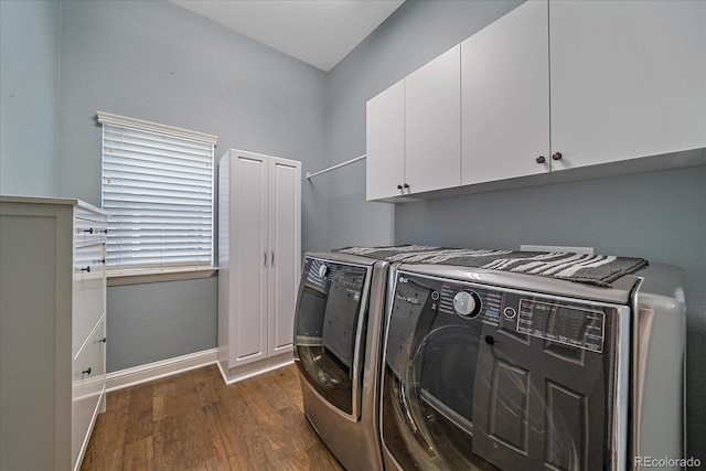 laundry area featuring cabinet space, dark wood-style floors, separate washer and dryer, and baseboards