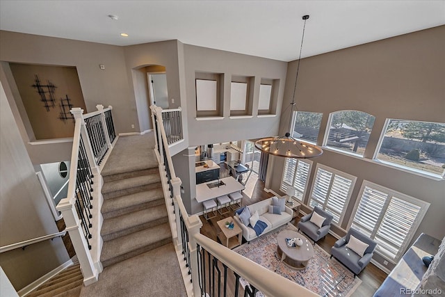 stairs featuring recessed lighting, baseboards, arched walkways, and carpet floors