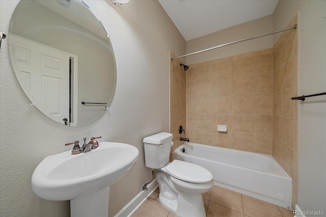 full bath with tile patterned floors, toilet, a sink,  shower combination, and baseboards