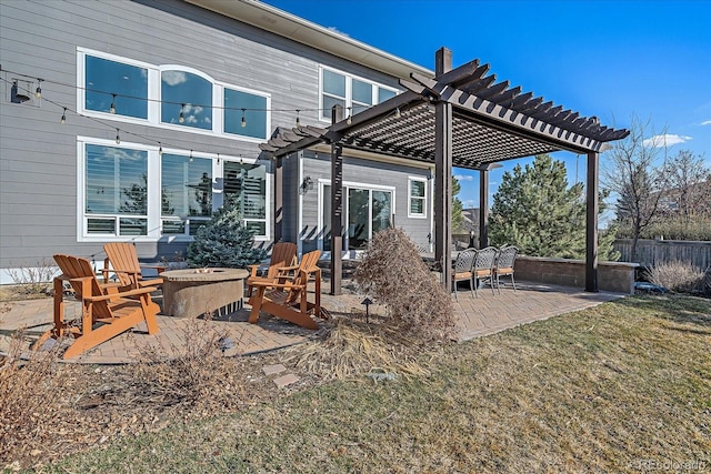 view of patio / terrace featuring fence, a fire pit, and a pergola